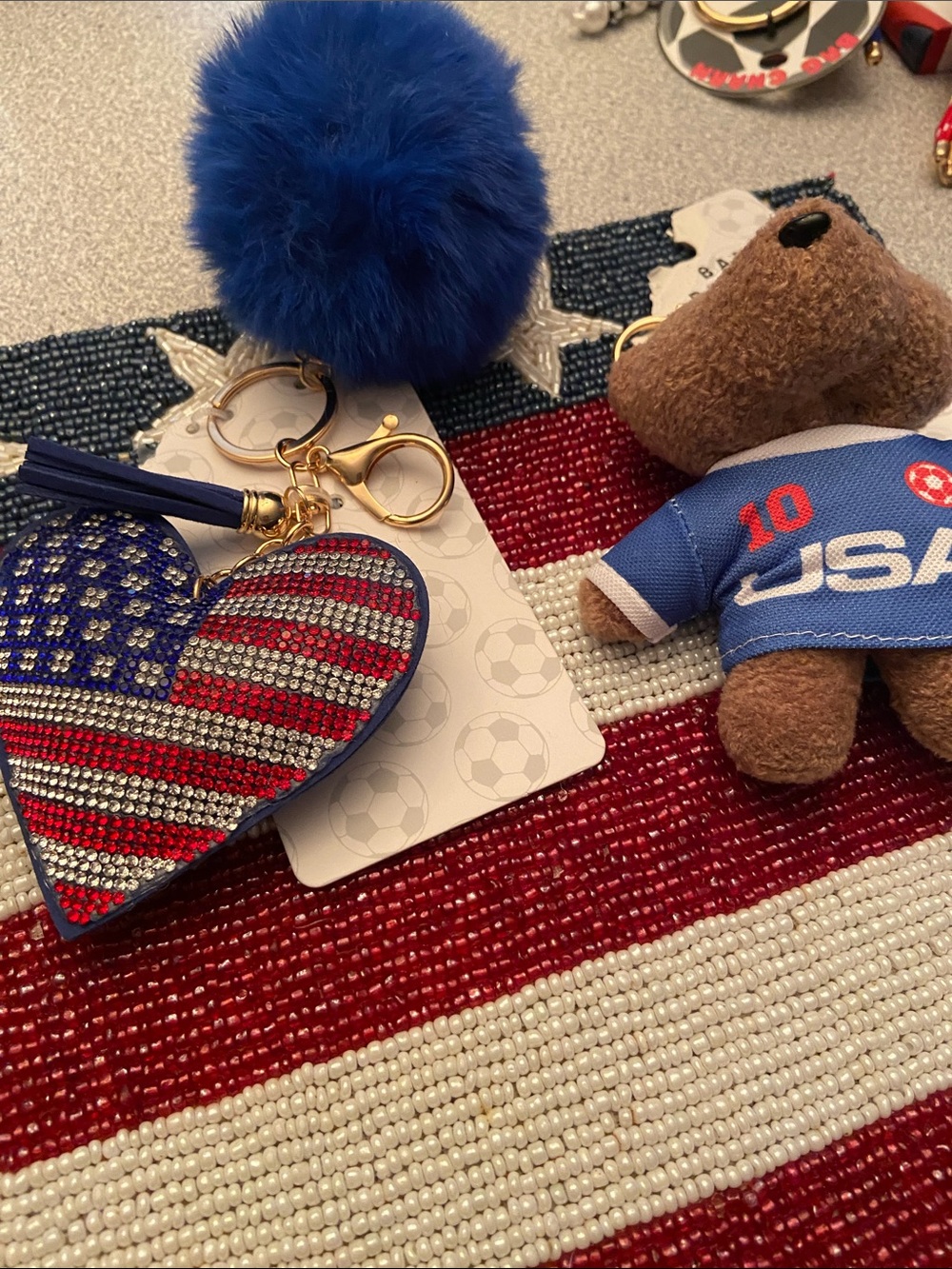 Banana Republic Blue Pom Pom Keychain with Red, White, and Blue Heart Charm